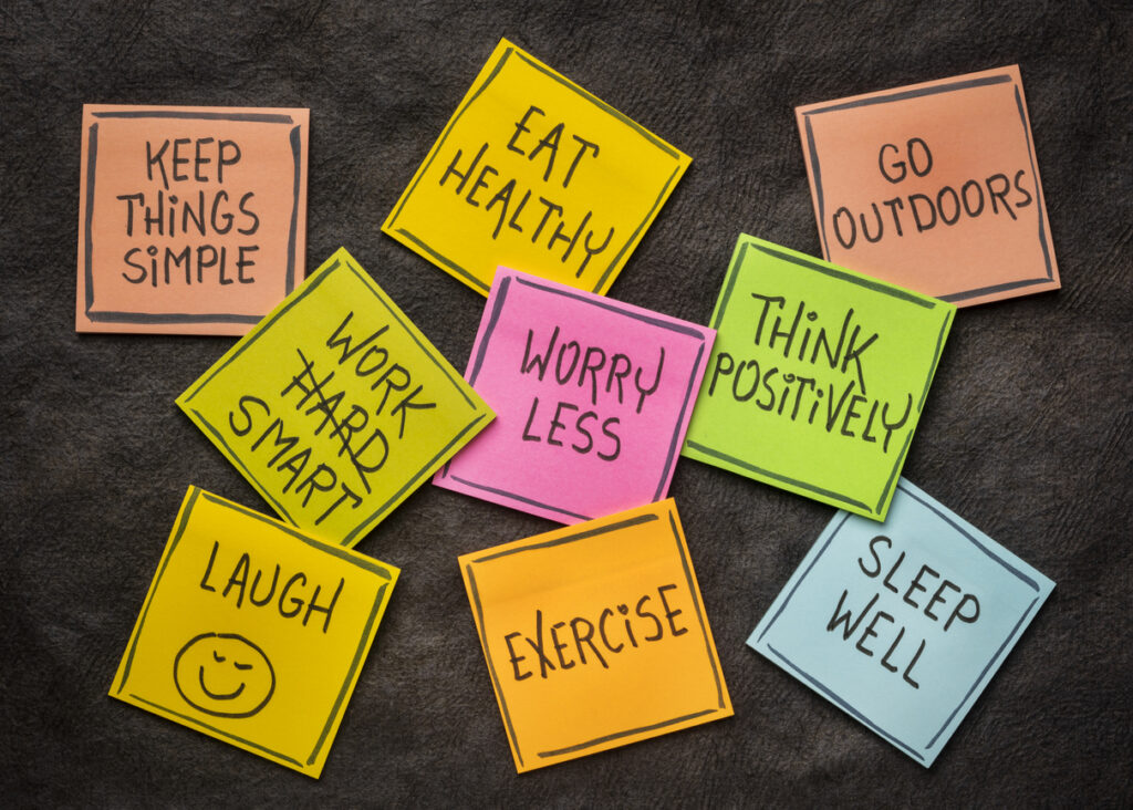 healthy lifestyle and wellbeing concept - a set of inspirational reminder notes against black textured paper